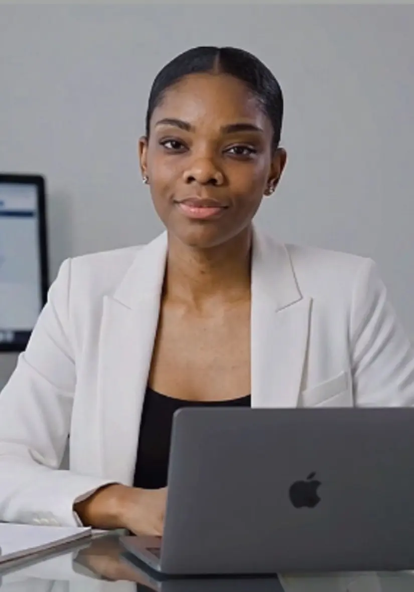 Helena Pedro seated behind a laptop in her workspace